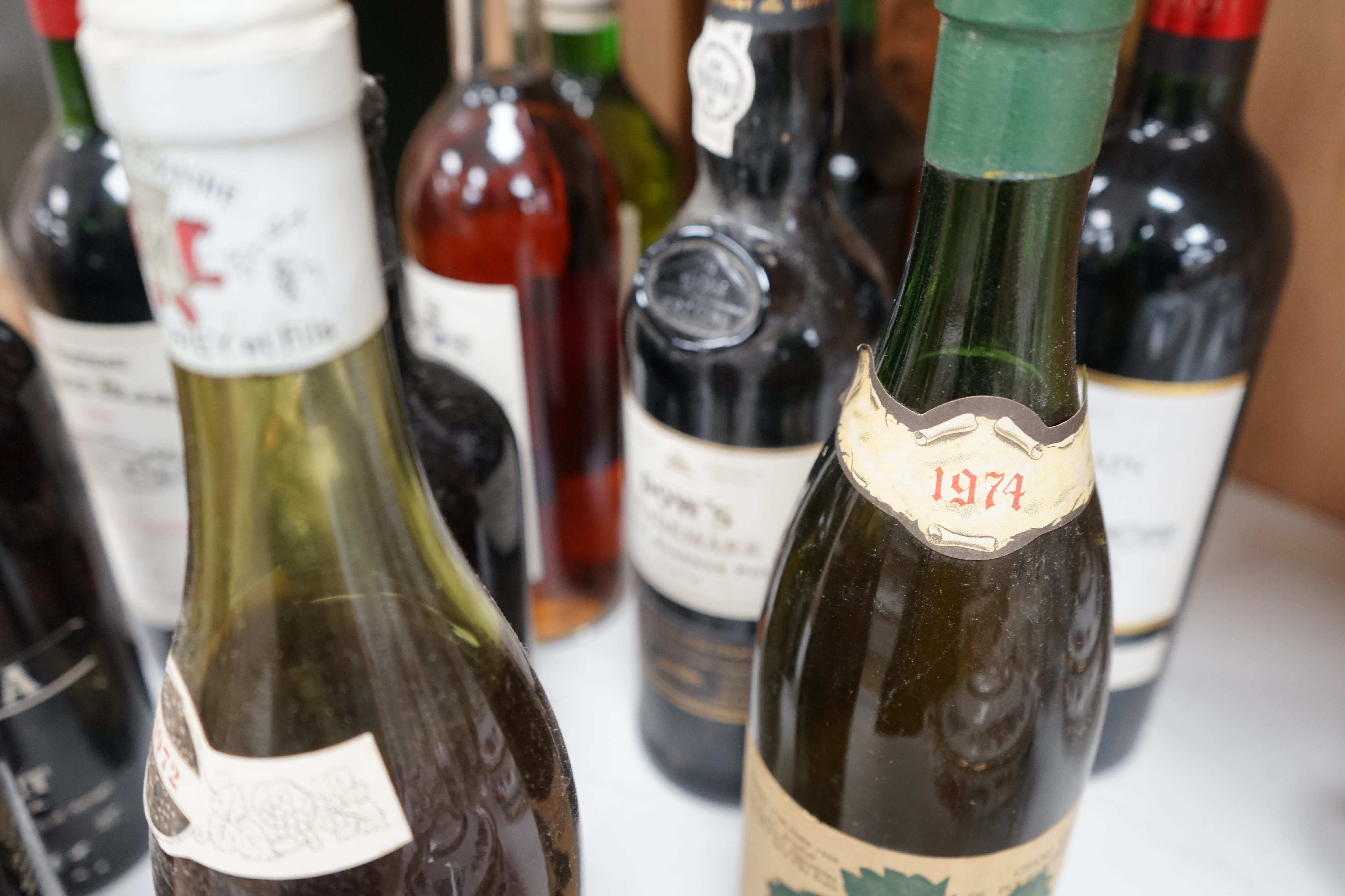 Seven bottles of mixed wines including St Emilion, Sauternes, Bordeaux, together with five bottles of mixed ports including Dow’s and two bottles of Fonseca port and a bottle of Calvados. Condition - unknown storage.